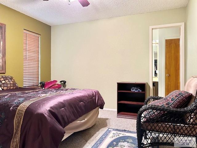 carpeted bedroom featuring a textured ceiling and ceiling fan