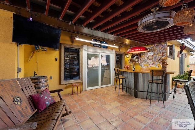 bar with tile patterned floors and wooden counters