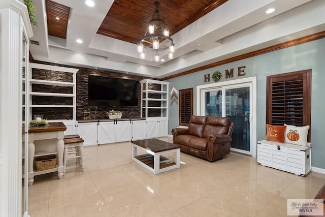 living room featuring a chandelier, a tray ceiling, and wood ceiling