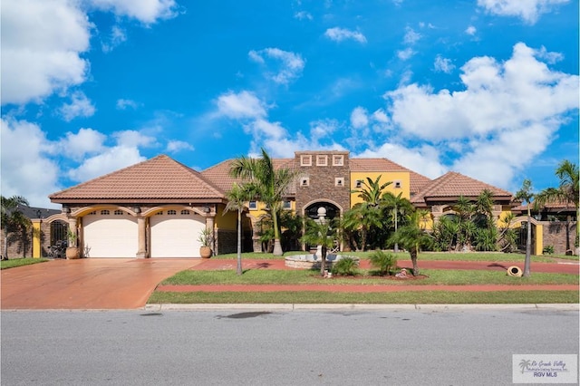 mediterranean / spanish house with a garage