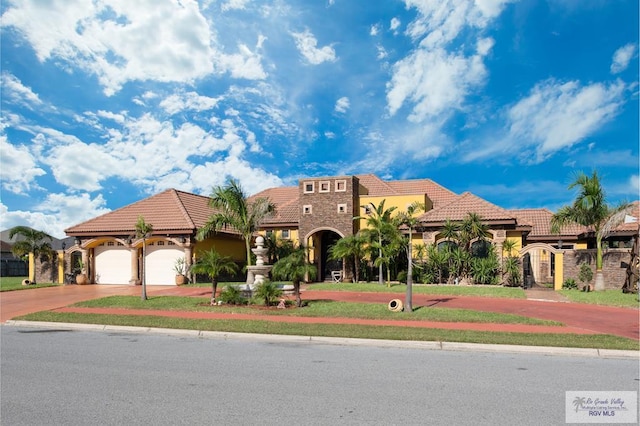 mediterranean / spanish-style home with a garage