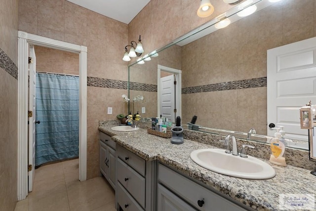 bathroom featuring tile patterned flooring, tile walls, and vanity