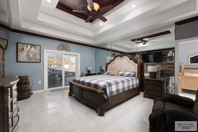 bedroom featuring a tray ceiling, ceiling fan, and access to exterior