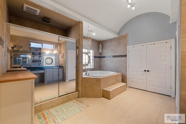 bathroom featuring vanity, shower with separate bathtub, tile patterned floors, and lofted ceiling