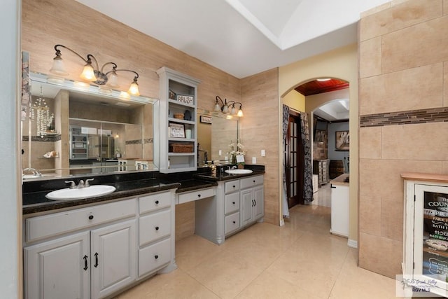 bathroom featuring tile walls, tile patterned flooring, and vanity