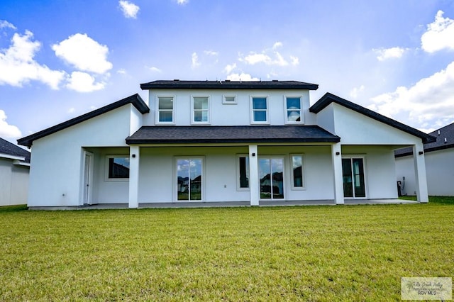 back of property featuring a patio area and a yard