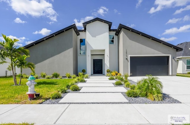 view of front of property with a front lawn and a garage