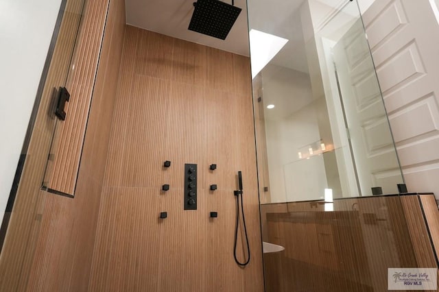 bathroom featuring a shower with door