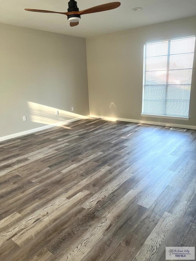 unfurnished room with ceiling fan and dark wood-type flooring