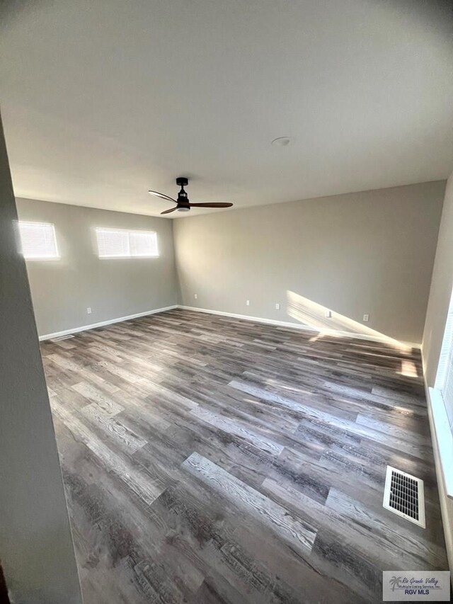 unfurnished room with ceiling fan and wood-type flooring