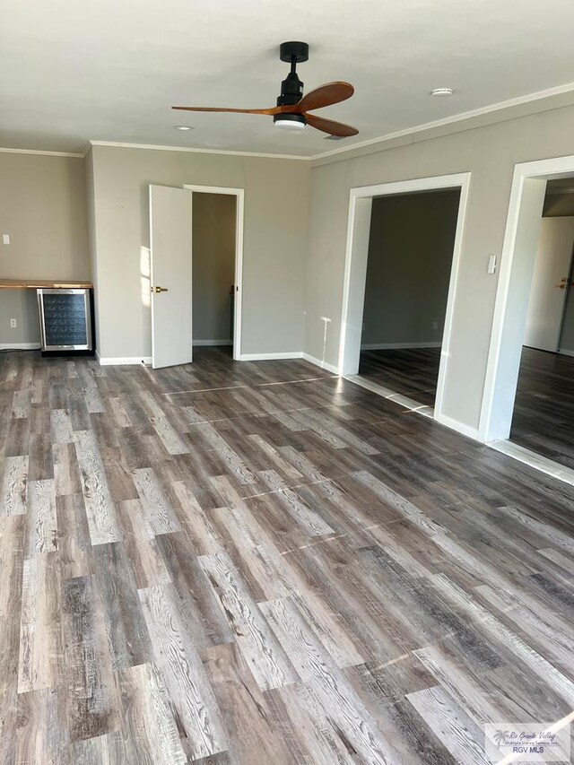 unfurnished living room featuring crown molding, ceiling fan, and wood-type flooring