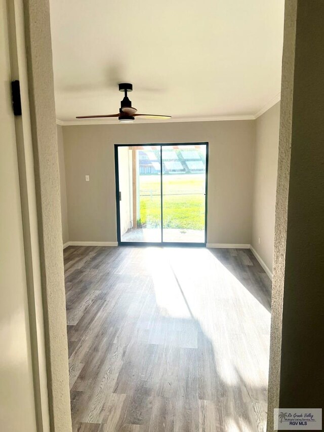 unfurnished room with wood-type flooring, ceiling fan, and crown molding