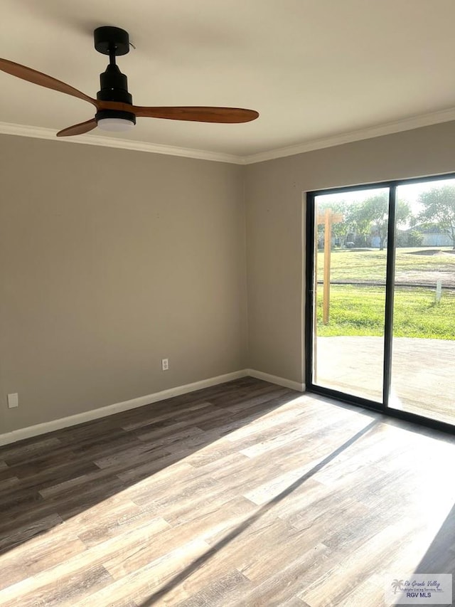 unfurnished room featuring ceiling fan, wood-type flooring, and ornamental molding