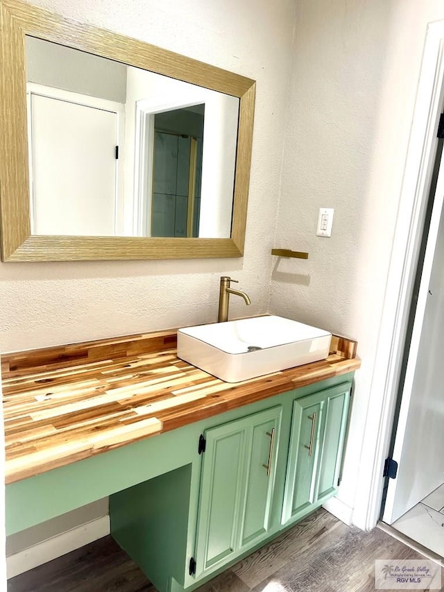 bathroom with hardwood / wood-style floors and vanity