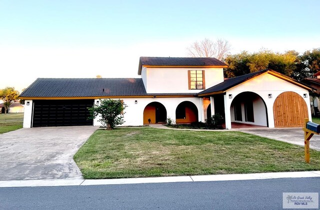 mediterranean / spanish-style home with a front lawn