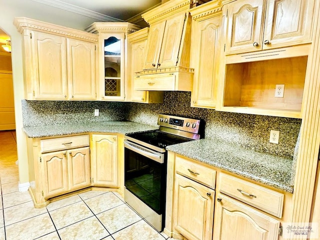 kitchen with light brown cabinetry, light stone counters, ornamental molding, light tile patterned floors, and stainless steel electric range oven