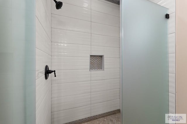 bathroom with tiled shower