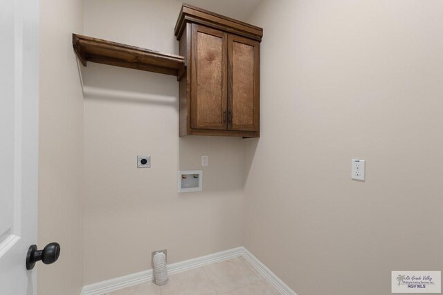 clothes washing area with hookup for a washing machine, light tile patterned floors, and electric dryer hookup