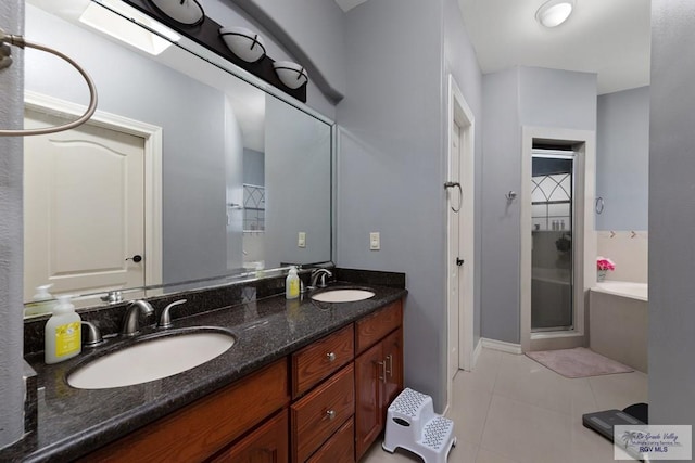 bathroom with vanity, tile patterned flooring, and shower with separate bathtub