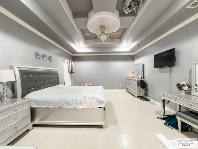 bedroom with a tray ceiling, ceiling fan, and ornamental molding