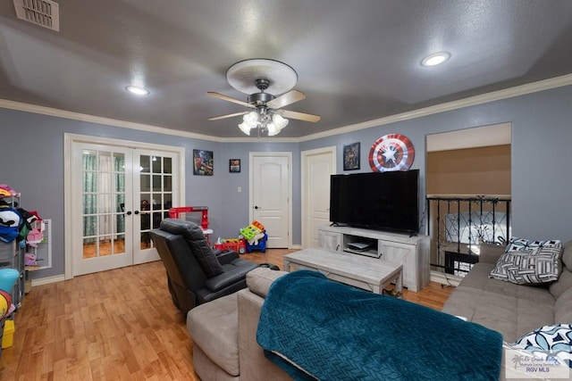 living room with crown molding, light hardwood / wood-style flooring, ceiling fan, and french doors