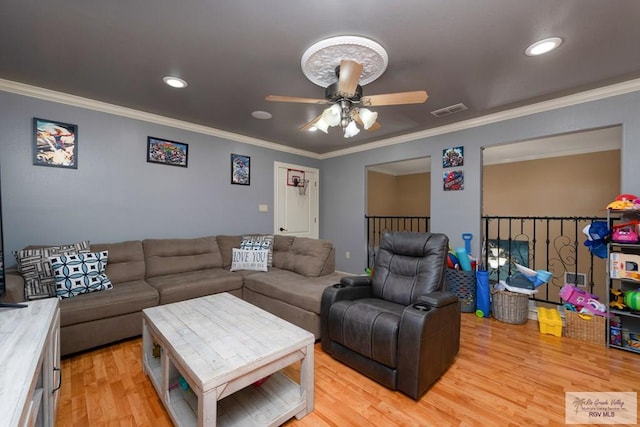 living room with crown molding, ceiling fan, and light hardwood / wood-style flooring