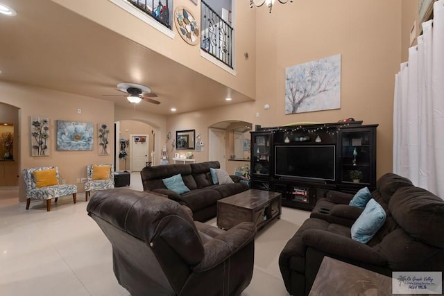 living room featuring a high ceiling and ceiling fan