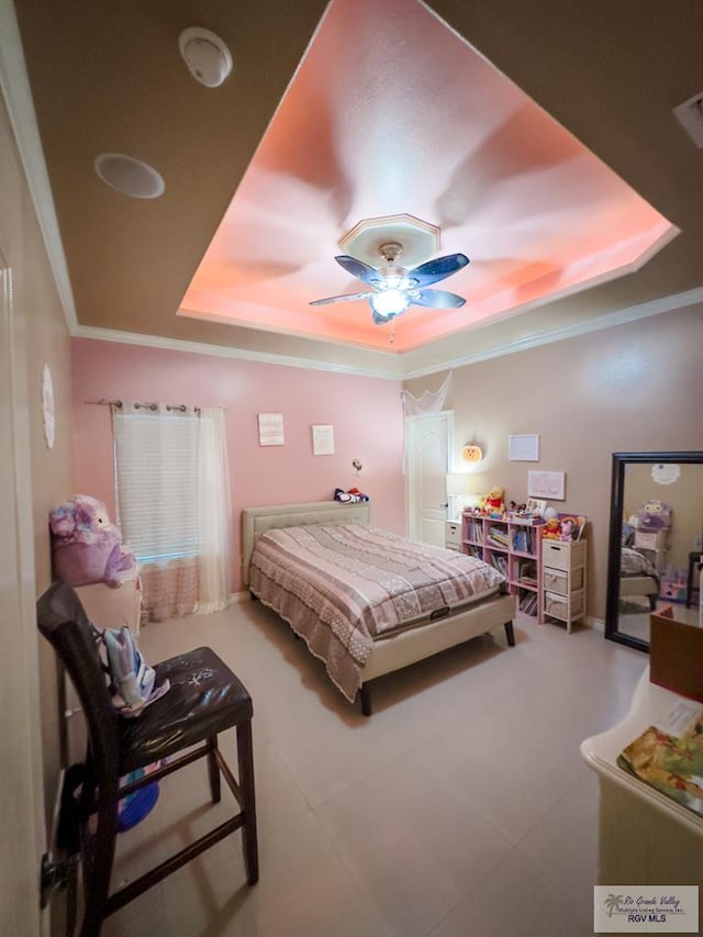 bedroom featuring a tray ceiling, ceiling fan, and crown molding