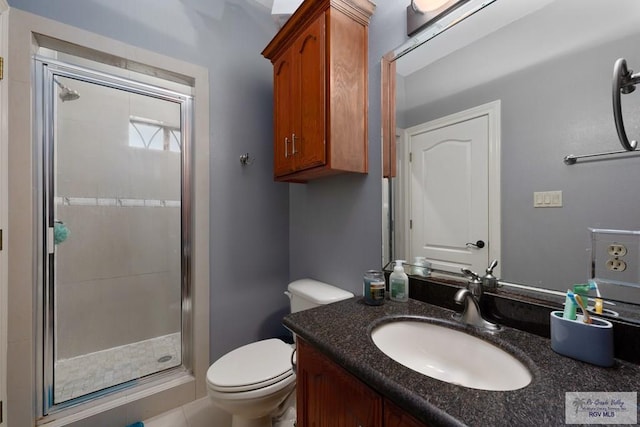 bathroom with an enclosed shower, vanity, and toilet