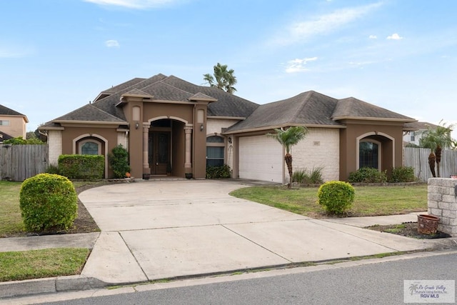 view of front facade with a garage and a front yard