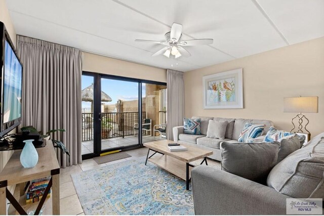 tiled living room with ceiling fan