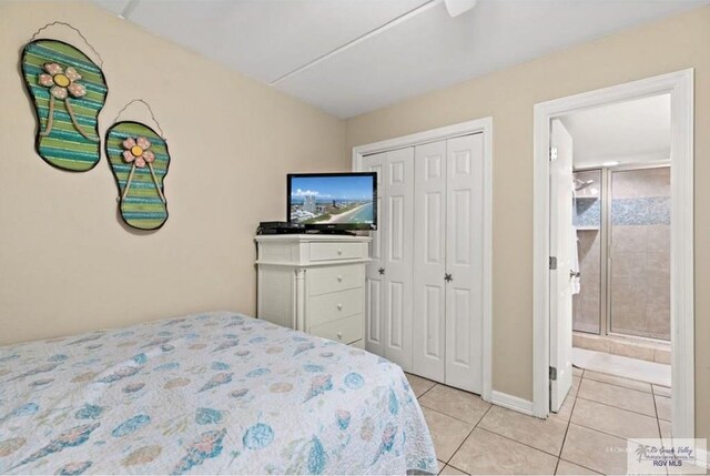 4300 Gulf Blvd Unit 105, South Padre Island, TX 78597 - tiled bedroom featuring connected bathroom and a closet