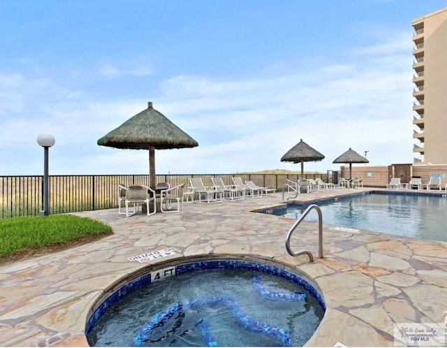 view of swimming pool featuring a patio area and a community hot tub