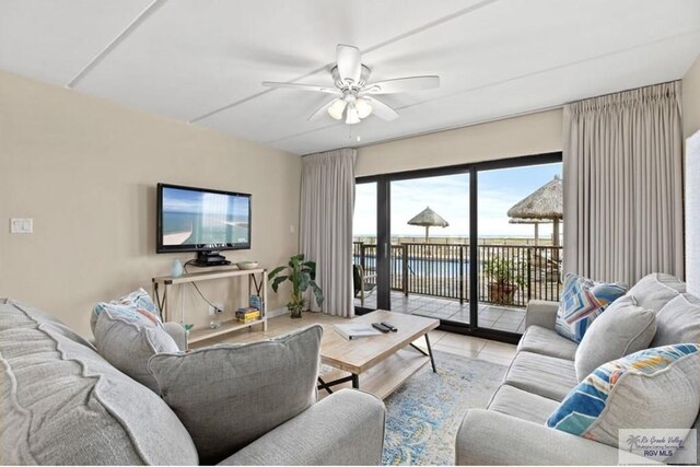 living room featuring ceiling fan and light tile patterned floors