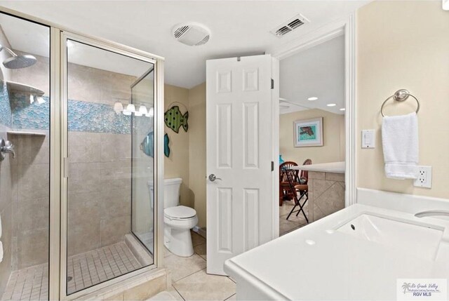 4300 Gulf Blvd Unit 105, South Padre Island, TX 78597 - bathroom featuring tile patterned flooring, a shower with door, and toilet