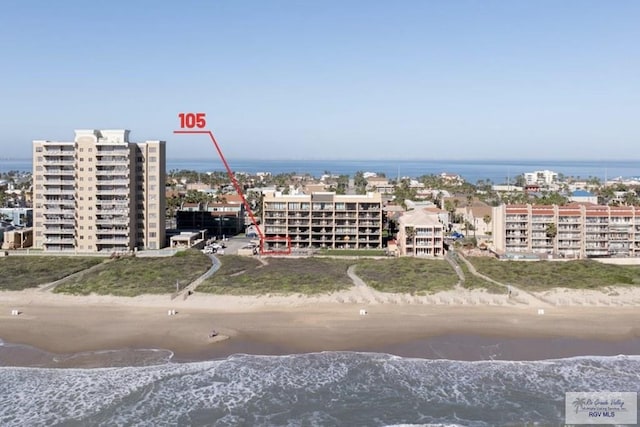 drone / aerial view featuring a water view and a view of the beach