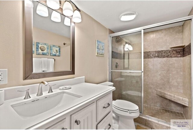 4300 Gulf Blvd Unit 105, South Padre Island, TX 78597 - bathroom featuring vanity, an enclosed shower, and toilet
