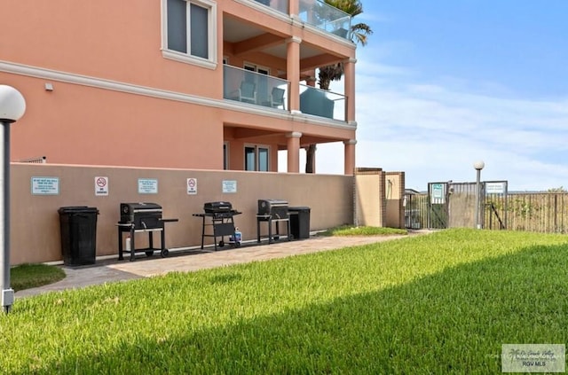 back of house featuring a yard and a patio