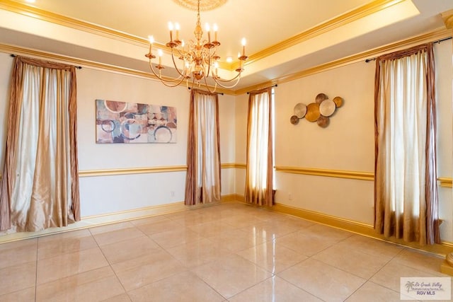 tiled spare room featuring ornamental molding, a raised ceiling, a chandelier, and baseboards