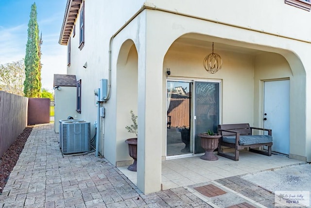 view of patio / terrace with central AC and fence