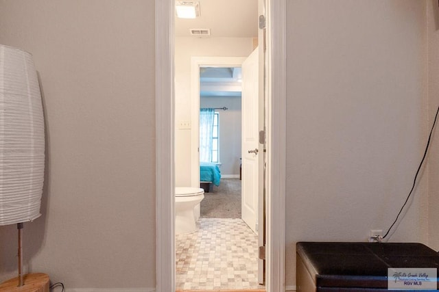 bathroom with toilet and visible vents