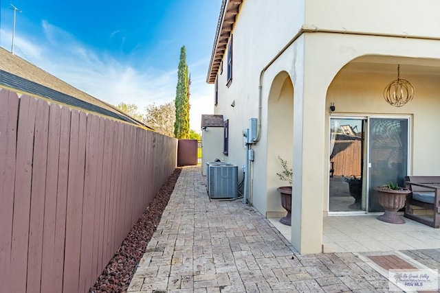 exterior space with fence and central AC unit