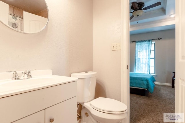 bathroom with a ceiling fan, a textured wall, toilet, ornamental molding, and vanity