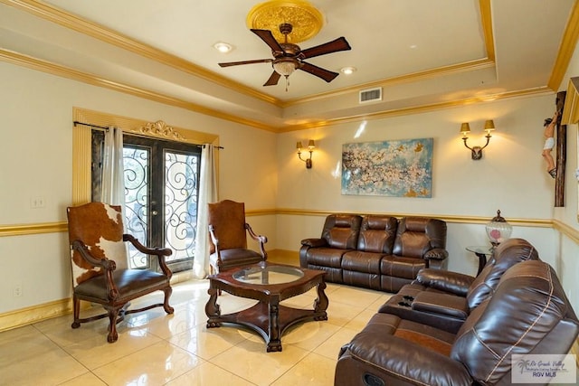 living area with visible vents, a raised ceiling, crown molding, and french doors