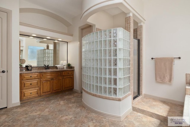 5713 Spicewood, Harlingen, TX 78552 - full bath featuring a tile shower, vanity, stone finish floors, and baseboards