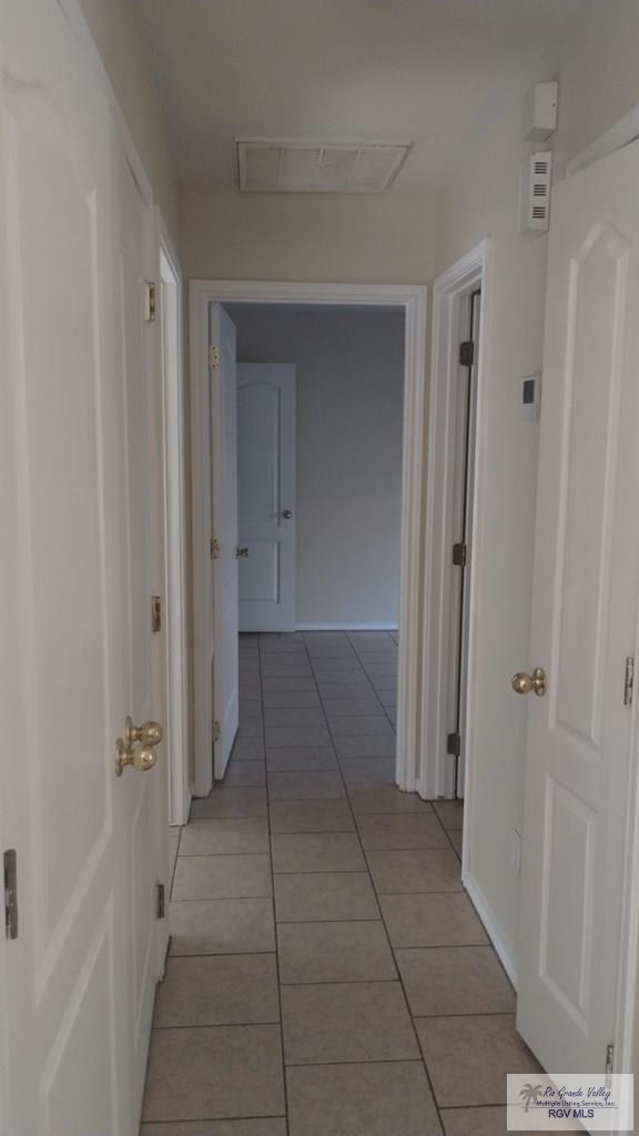 corridor with light tile patterned floors