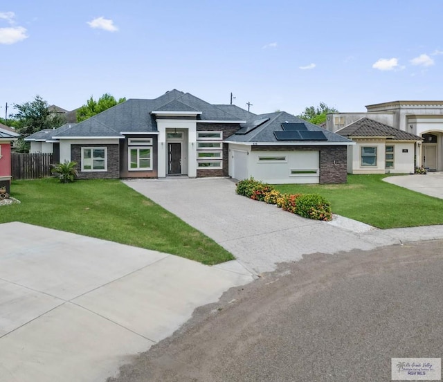 prairie-style house with a front yard and solar panels