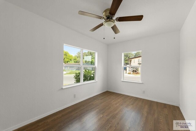 unfurnished room with dark hardwood / wood-style floors and ceiling fan