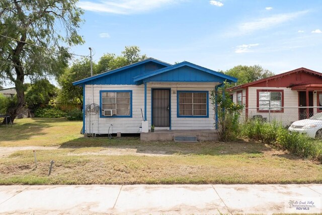 bungalow-style home with a front lawn