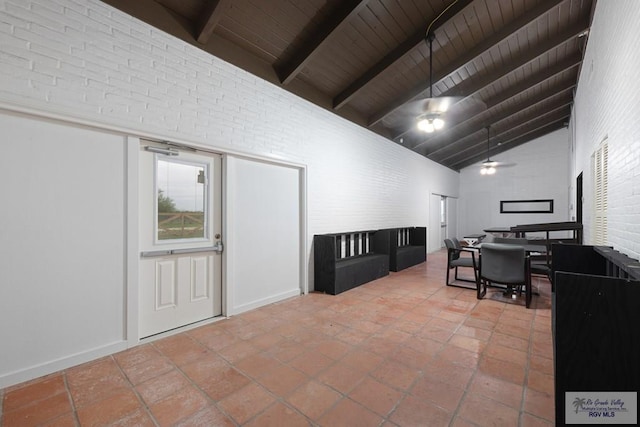 interior space with brick wall, high vaulted ceiling, wooden ceiling, beamed ceiling, and tile patterned floors